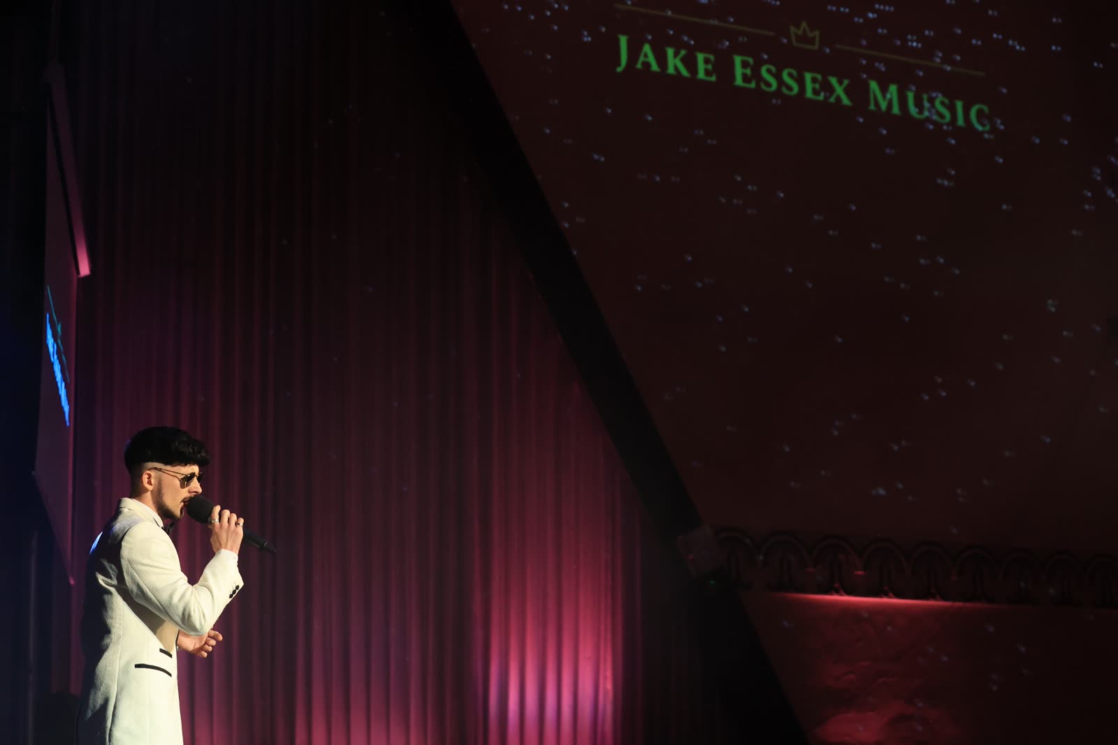 Jake Essex singing on stage